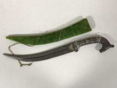 A decorative Indian dagger with damascus blade and horse head grip,