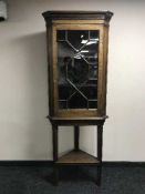 A Victorian oak glazed door corner cabinet on stand