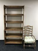 An early 20th century rush seated pine armchair and set of pine bookshelves