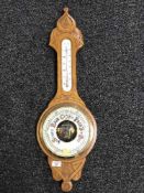 A carved oak cased banjo barometer