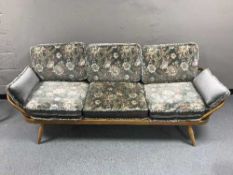 An Ercol elm three seater settee or day-bed