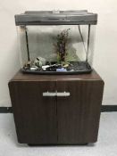 A Fish Box fish tank with accessories on double door stand