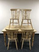 A pine kitchen table fitted two drawers and four chairs