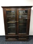 An antique pine glazed door bookcase
