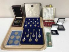 A tray of cased Exquisite tea spoons, set of United Kingdom commemorative crowns, a five pound coin,