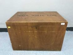 A teak storage box with brass handles