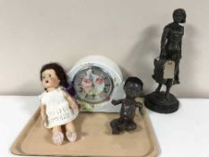 A painted mantel clock, two plastic dolls,