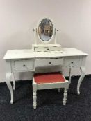 A contemporary cream dressing table with mirror and stool