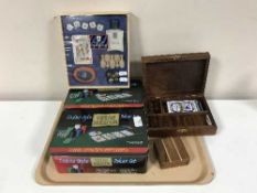 A tray of two boxed Texas Holdem poker sets, games compendium, brass box of dominoes and dice,