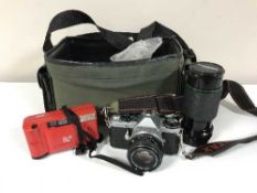 A camera bag containing Pentax ME Super camera, one other camera,