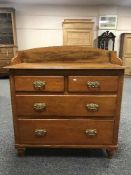 A pine chest of four drawers
