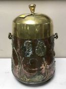 An Art Nouveau brass and copper lidded log bucket