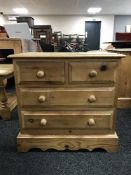 A pine four drawer chest