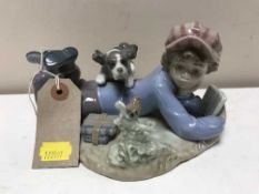A Lladro figure - boy reading with puppy number 5451