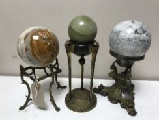 Three early 20th century metal stands surmounted by spherical marble balls