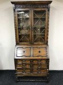 An Edwardian carved oak bureau bookcase
