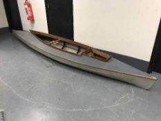 A wooden-framed and canvas two-man open canoe, with paddles, etc.