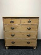 An antique pine five drawer chest