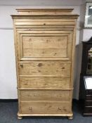 A pine cupboard fitted with a drawer