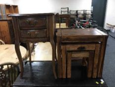 A French style two drawer bedside stand and nest of three pine tables