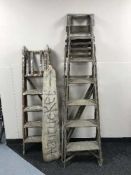 Two sets of folding wooden step ladders and a piece of driftwood
