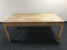 A rectangular pine kitchen table