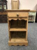 A pine bedside chest fitted with a drawer