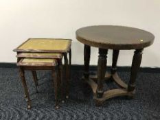 A circular oak lamp table and nest of three tables