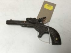 A small cast metal pistol stamped 'Lion'