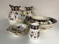 A six piece pottery blue and gilt with floral decoration toilet set