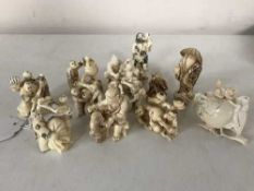 A group of twelve Japanese netsukes depicting figures,