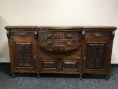 A late Victorian carved mahogany bow fronted sideboard