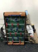 A table football game and a bag of un-framed posters and maps