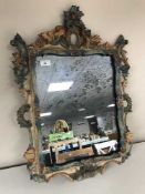 A decorative framed rococo style mirror