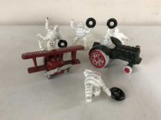 Six small cast iron Michelin man figures