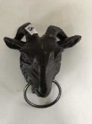 A cast metal ram's head