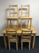 A pine kitchen table and four chairs