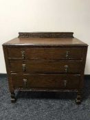 An early twentieth century carved oak three drawer chest