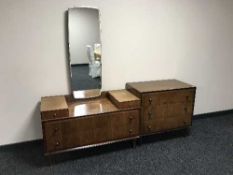 A mid twentieth century walnut three drawer chest with matching dressing chest