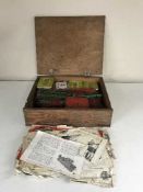 A pine box of loose Meccano and instructions