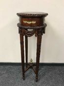 An Empire style mahogany torchere