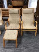 A pair of beech framed chairs in webbing fabric with headrests and a stool
