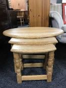 A nest of three oak tables