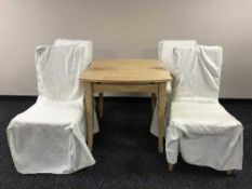 An extending beech kitchen table and four chairs
