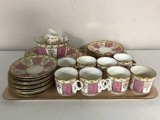 A tray of antique pink cream and gilt tea service