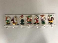 A cast metal wall rack - Seven dwarfs
