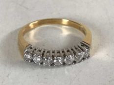 An 18ct gold seven stone diamond ring