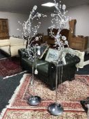 A pair of chrome and glass floor lamps