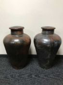 A pair of large terracotta lidded urns