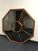A large octagonal teak framed sectional mirror
